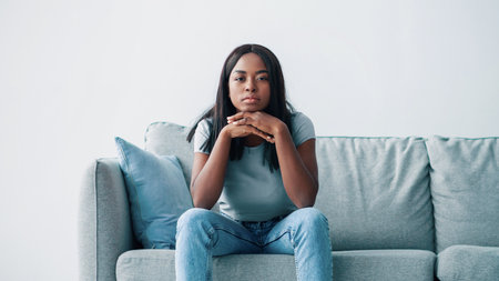 Young married black couple ignoring each other after having fightの写真素材