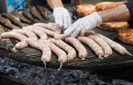 Street fast food festival, grilled sausages at bbqの写真素材