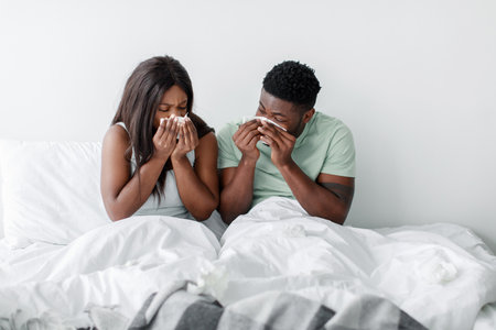 Couple Sharing a Moment Together While Sitting on Their Bed in a Cozy Roomの写真素材