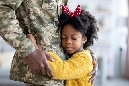 Soldier Embraces Daughter in Tender Reunion During Military Homecoming Eventの写真素材