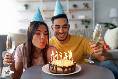 Celebrating a Joyful Moment With a Birthday Cake, Candles, and Party Hats in a Cozy Living Room Settingの写真素材