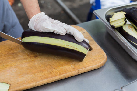 Street fast food festival, chefs chopping eggplantの写真素材