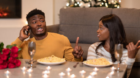 Displeased Woman Argues With Man on Phone During a Bad Date Indoorsの写真素材