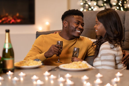 Happy Couple Enjoying Romantic Dinner and Champagne Indoors for Special Celebrationの写真素材