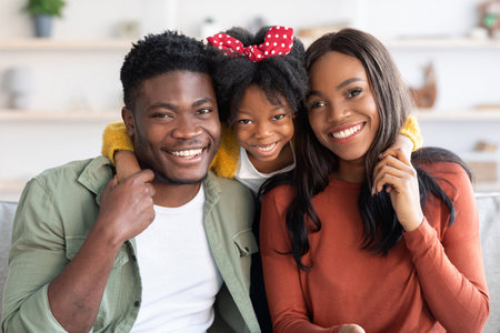 Happy Family Enjoying Time Together in a Cozy Living Room With Smiles and Loveの写真素材