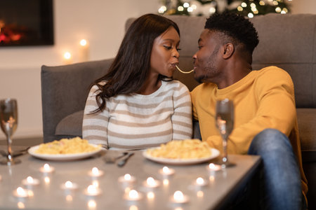 Loving Couple Enjoys Spaghetti Dinner Together for a Romantic Valentines Day Celebration at Homeの写真素材