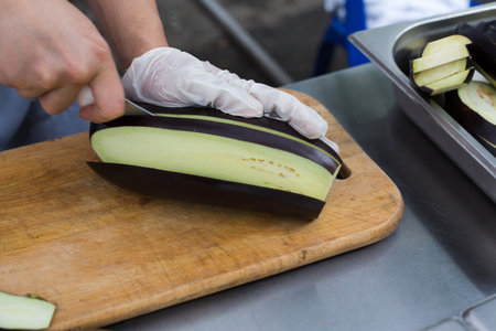 Street fast food festival, chefs chopping eggplantの写真素材