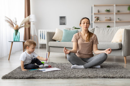Mother and Child Practice Mindfulness Together in a Cozy Living Room Setting During a Peaceful Afternoonの写真素材