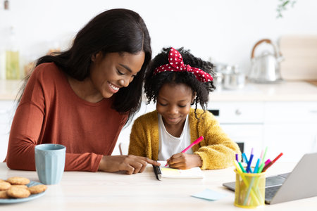 Mother and Daughter Share a Joyful Moment While Learning and Drawing Together at Homeの写真素材