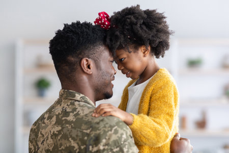 Father and Daughter Share a Joyful Moment Indoors During a Family Reunion Celebration on a Sunny Afternoonの写真素材