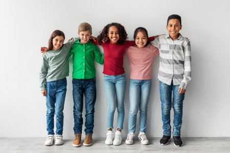 Happy Diverse Preteen Children Smiling Together Over a Gray Backgroundの写真素材