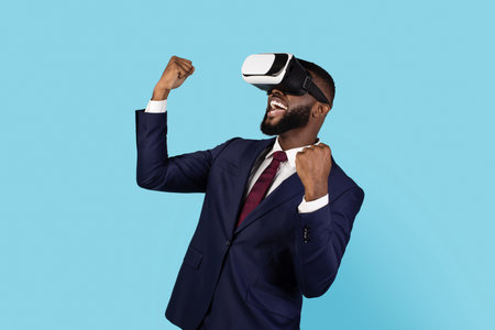 Modern Technologies. Joyful Black Businessman Wearing VR Eyeglasses Celebrating Successの写真素材
