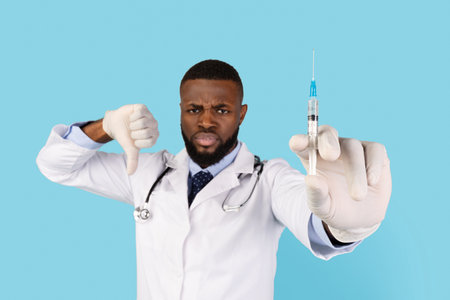 Black Male Doctor Holding Syringeの写真素材