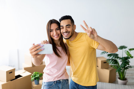 Young Couple Taking a Selfie While Moving Into Their New Home During the Daytime