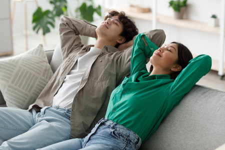 Young Couple Enjoying a Relaxing Moment Together in Their Living Room on a Peaceful Morningの写真素材