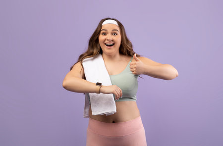 Cheerful Young Female in a Sports Uniform Shows Excitement While Giving a Thumbs Upの写真素材