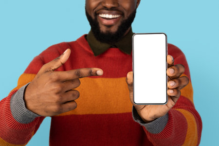 Mobile Offer. Smiling Black Man Pointing At Black Smartphone In Hand