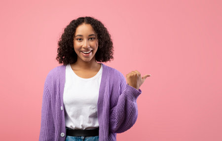 Cheerful Young Black Woman Inviting Viewers to Explore Offers With a Welcoming Gestureの写真素材