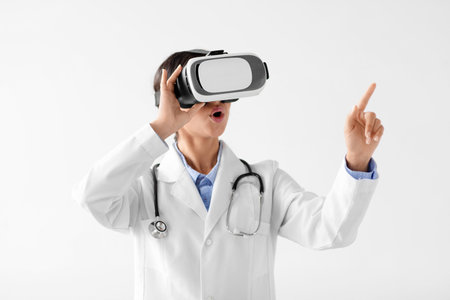Surprised Young Indian Woman Doctor Explores Medical Technology Using Virtual Reality Glassesの写真素材