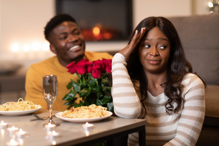 Girlfriend Ignores Boyfriend With Roses During Disappointing Valentines Day Dinner Indoorsの写真素材