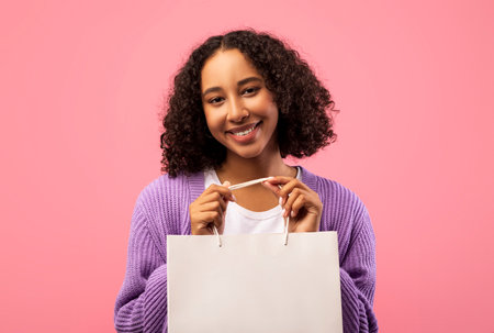 Young Woman Showcases Shopper Bag for Brand Logo Mockup in Bright Pink Studio Backgroundの写真素材