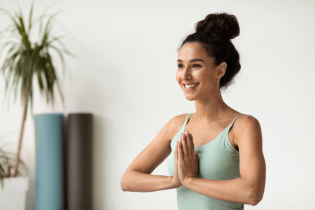 Smiling Young Woman Practicing Meditation at Home in a Calm and Peaceful Environmentの写真素材