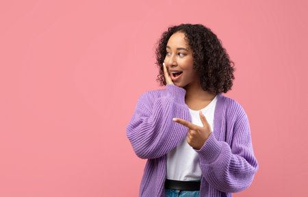 Excited Young Black Lady Amazed by a Big Sale in a Pink Studio Backgroundの写真素材