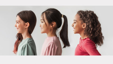 Collage of Happy Multiethnic Preteen Girls Posing Side View on White Background in Studioの写真素材