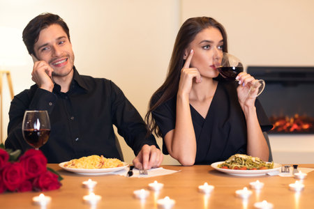 Couple Enjoys a Romantic Dinner at Home With Candlelight and Delicious Pasta Dishes in an Intimate Settingの写真素材