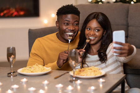 Happy African American Couple Taking Selfie at Home While Celebrating Valentineâs Day Dinnerの写真素材