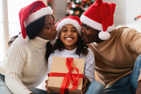 Happy Black Family Shares Love and Joy During Christmas Celebration at Homeの写真素材