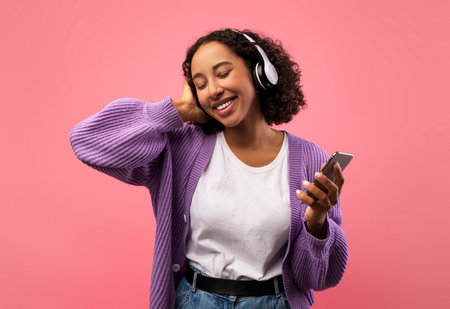 Positive Young Woman Enjoying Music With Headphones and Cellphone in a Bright Setting