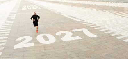 Runner on a Path Marked With Future Years in a Paved Urban Area