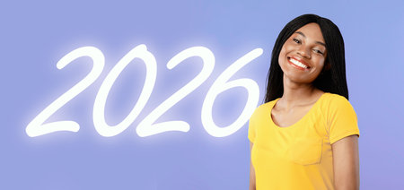 Confident Millennial Girl Posing With Arms Folded in Front of Purple Background Smiling at Cameraの写真素材