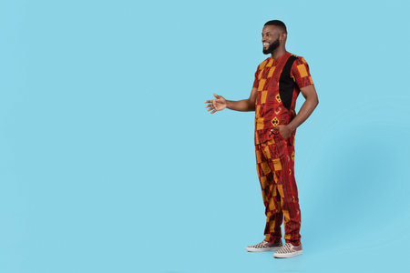 Handsome Black Man In Traditional African Costume Giving Hand For Handshakeの写真素材