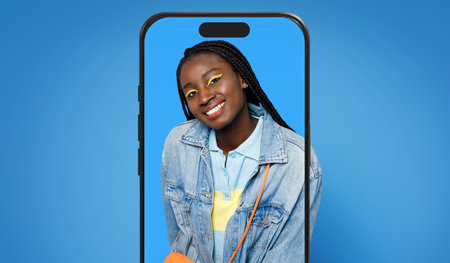 Smiling Young Woman Posing With Headphones Against a Blue Background