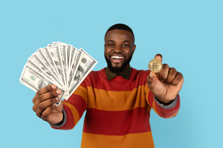 Crypto Trading. Excited Black Man Holding Golden Bitcoin Coin And Dollar Cashの写真素材