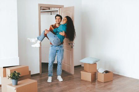 Happy Couple Moving Into New Home Together in a Bright, Empty Room