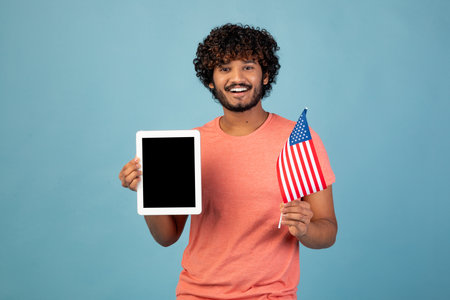 Positive Student Shares American Flag and Tablet to Promote Educational App in Studioの写真素材