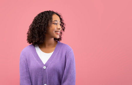 Smiling Young Black Lady in Casual Wear Posing Against a Pink Backgroundの写真素材