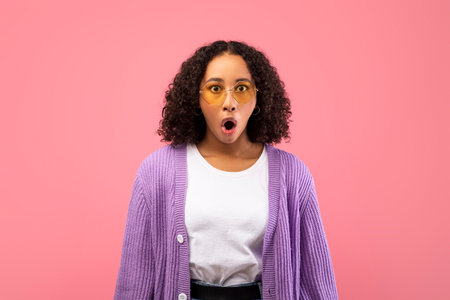 Shocked Young Black Lady Expresses Surprise in Pink Studio Backgroundの写真素材