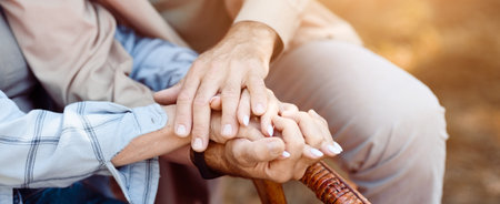 Couple Holding Hands in a Serene Outdoor Setting During a Warm Afternoon