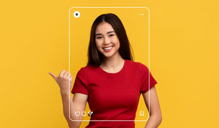 Young Woman Smiles and Poses With Joy in a Vibrant Yellow Backdrop, Showcasing Creativityの写真素材