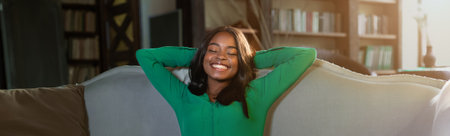 Smiling Woman Relaxing on Sofa in Cozy Living Room During Afternoonの写真素材