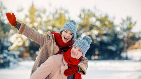 Joyful Winter Day With Friends Enjoying Time in the Snowy Landscapeの写真素材