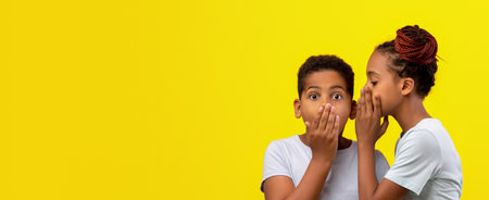 Kids Sharing a Secret on a Bright Yellow Background in a Playful Moment