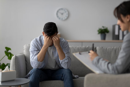 Stressed Man Receives Psychotherapy for Depression in a Calming Office Environmentの写真素材