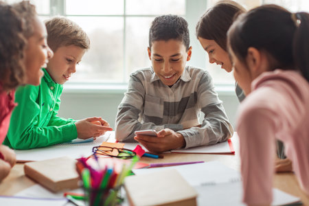 Excited Black Schoolboy Shares Fun Moments With Friends in Modern Classroom During Break Time