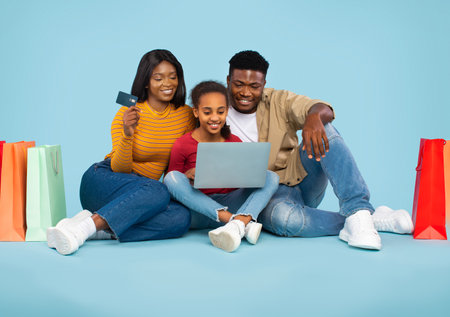 Family Enjoys Online Shopping Together During the Afternoon at Homeの写真素材