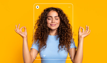 Woman in Meditative Pose Creates Positive Energy Against a Bright Yellow Backgroundの写真素材